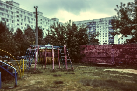 the thrown playground with a rusty swingの写真素材