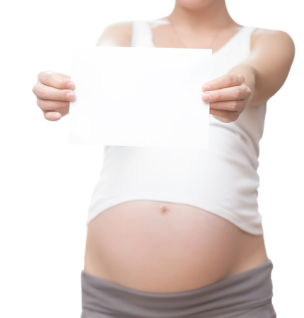 the pregnant woman with a clean sheet of paper for textの写真素材