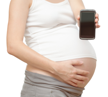 belly of the pregnant woman.holds in hand phone.  の写真素材