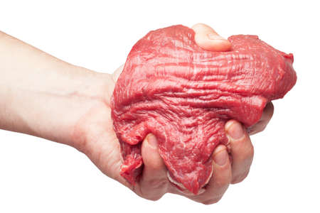 the man's hand squeezes a piece of fresh beef. it is isolated on a white background の写真素材