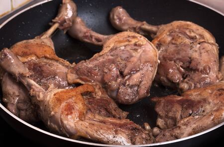 raw duck legs are fried in a pan.の写真素材