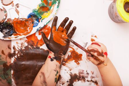 view from above. Child hands soiled in a paint. bodyartの写真素材