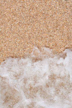 sand texture and wave of the sea with foamの写真素材