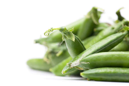 green fresh peas isolated on white backgroundの写真素材