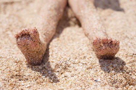 kid feet on the sand. rest and childhood. sea air.