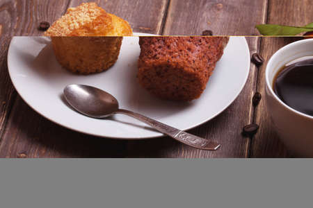 tangerine cake and coffee cup on a wooden table. sweet breakfast.の写真素材