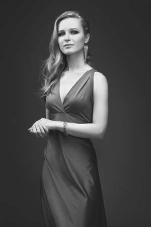 sexy girl in evening dress posing over dark backgroundの写真素材