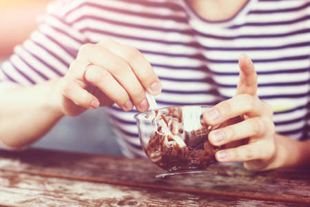 The girl is eating ice cream, a ring on her arm. Concept yummy relax