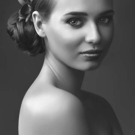 studio portrait of young beautiful girl on dark background. black and whiteの写真素材