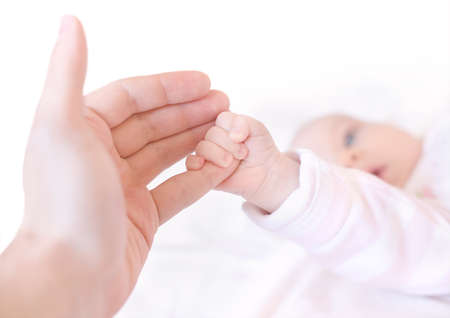 The baby holding parents finger