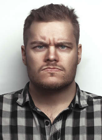 Funny portrait of a serious man. a man in the studioの写真素材