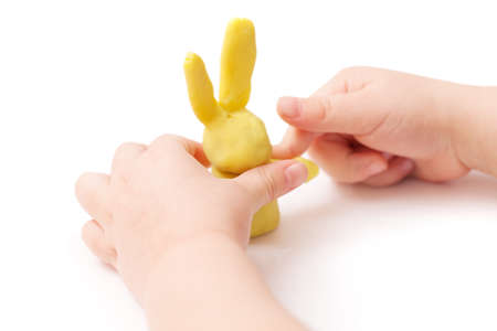 The child is playing with plasticine. Hand-made game. Isolatedの写真素材