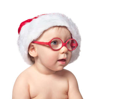 little cute baby in red Santa hat on white bacground. close up portrait. isolated