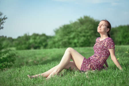 beautiful girl relaxing in the park on a sunny dayの写真素材