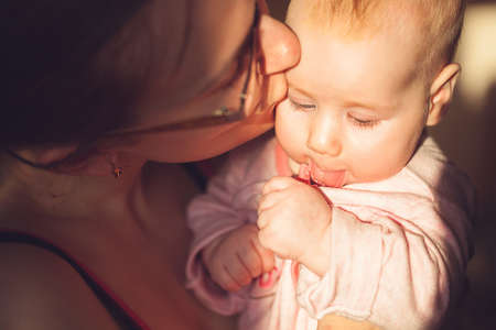 mother kisses the child. bright sunny weather.の写真素材
