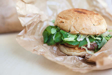 tasty hamburgers with a salad in a paper box on a table
