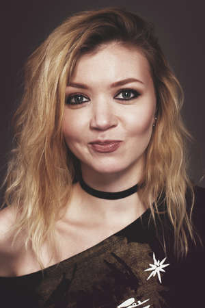 Rock baby. Fashion portrait of a young beautiful girl in the studioの写真素材