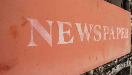 old red Newspaper box on brickwallの写真素材