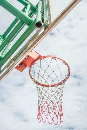 red basketball hoop and white cloud .