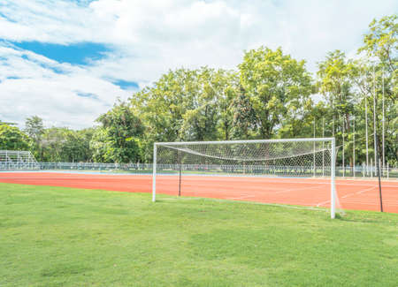 soccer goal in field with blue sky white cloud