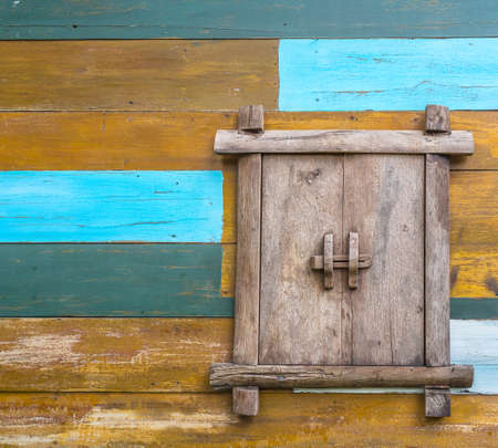 wooden window on colorful wooden wall paintedの写真素材