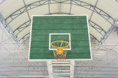 yellow Basketball hoop and green wooden panel