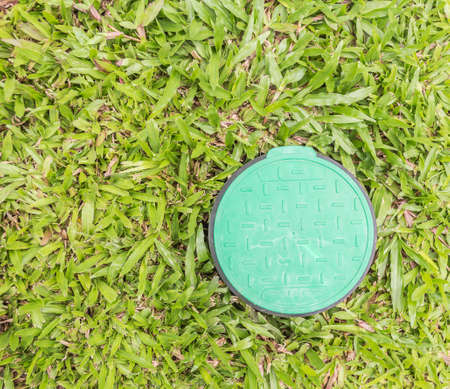 control valve lid  on the green grass fieldの写真素材