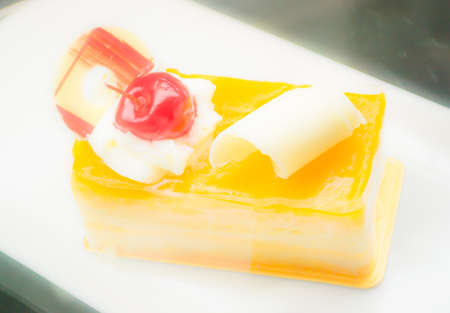 orange cake and red cherry  in soft tone image  .の写真素材