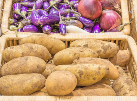 potato and onion harvested products on wooden basket.の写真素材