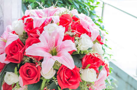 fake beautiful plastic Lilly and rose flower.の写真素材