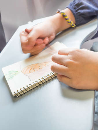 slow speed shutter image of Hand drawing carrot picture on notebook .の写真素材