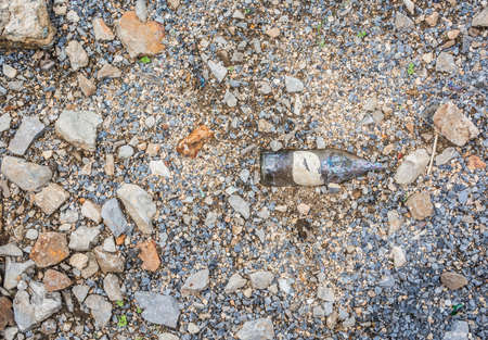 image of bottle and rock on ground .の写真素材