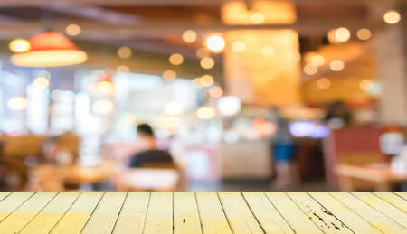Empty wood table and blurred coffee shop background . Empty wood table and blurred coffee shop background .