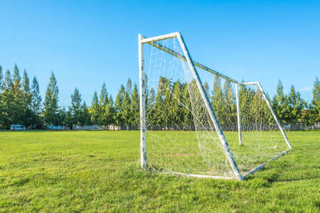 soccer goal in field with blue sky white cloud.の写真素材