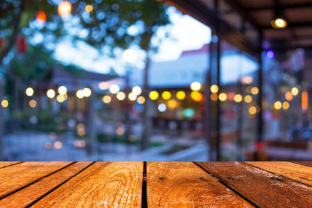 Empty wood table and Coffee shop blur background with bokeh image.の写真素材