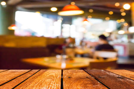 Empty wood table and Coffee shop blur background with bokeh image.の写真素材