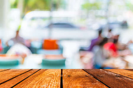 Empty wood table and Coffee shop blur background with bokeh image.の写真素材