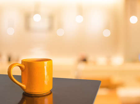 Empty wood table and Coffee shop blur background with bokeh image.の写真素材