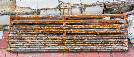 Close up old Steel rod for construction on broken tile floor.の写真素材