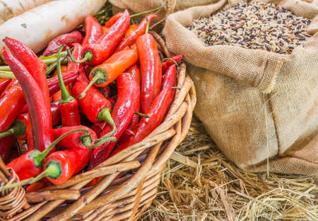 close up shot of rice in sag bag and chili in basket image.の写真素材