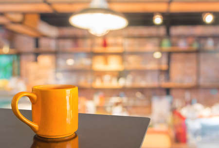 Empty wood table and Coffee shop blur background with bokeh image.