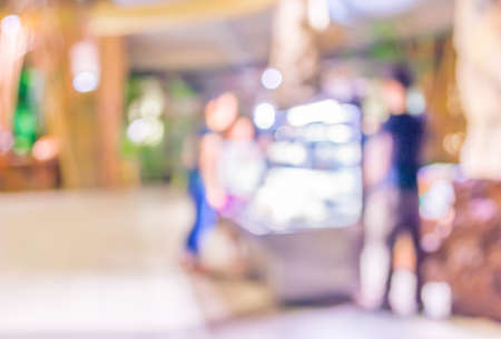 Coffee shop blur background with bokeh image .