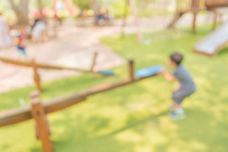 Defocused and blur image of children's playground at public park for background usage.の写真素材