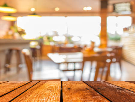 Empty wood table and Coffee shop blur background with bokeh image.の写真素材