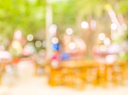 blur image of out door restaurant with green garden in background .の写真素材