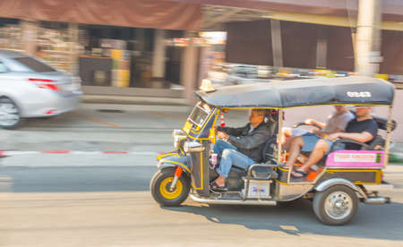 CHIANG MAI, THAILAND - february 28, 2015: Motion Blur image ofUnidentified driver and tourists in tuk-tuk vehicle on the road  at Ratchamankha road in Chiang Mai.のeditorial素材