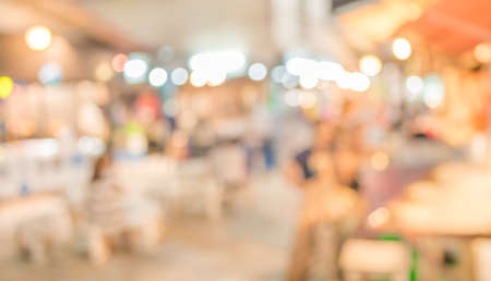 Image of blurred night market on street decorated with festive lights.の写真素材