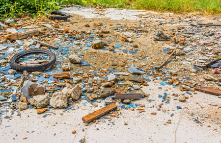 image of An old tyre in a broken glass zone for background usage.の写真素材