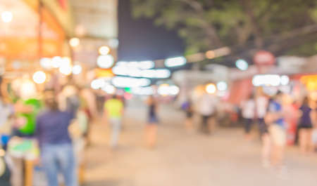 image of blurred background night market on street decorated with festive lights.の写真素材