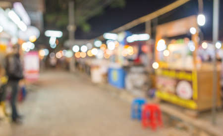 image of blurred background night market on street decorated with festive lights.の写真素材